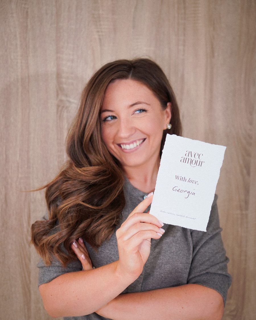 Georgia smiling, holding her With love card