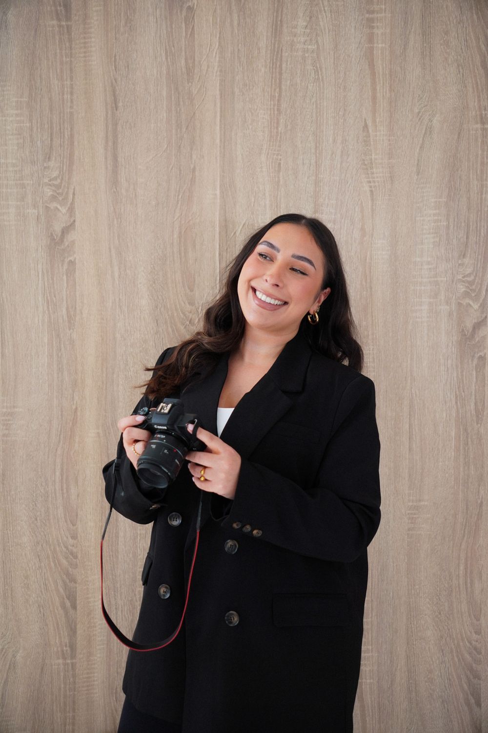 Nadiye laughing with a camera in hand